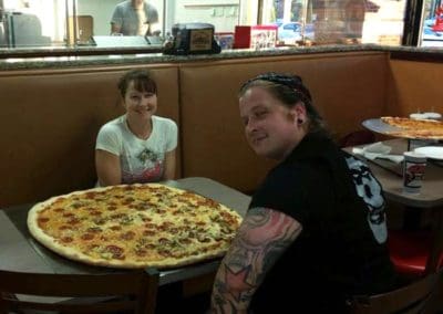 Two women trying the Brooklyn Pizzeria pizza challenge