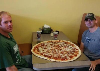 Two guys attempting the Brooklyn Pizzeria pizza challenge