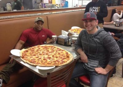 Two guys trying the Brooklyn Pizzeria pizza challenge